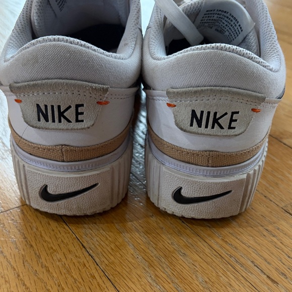 Nike White Low-Top Sneakers with Black Swoosh and Gold Accent - Picture 3 of 15